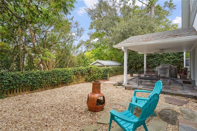 view of patio / terrace with grilling area, ceiling fan, and fence