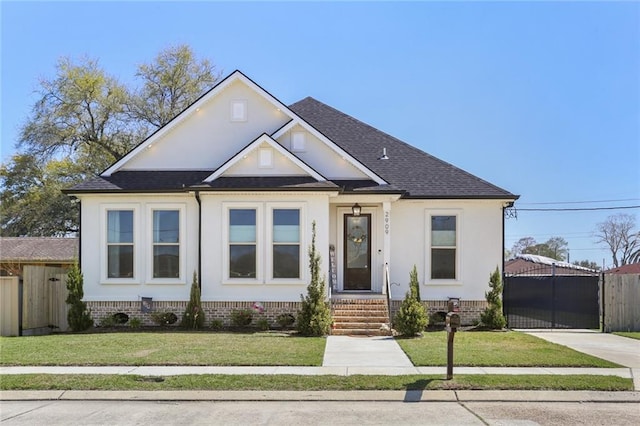 view of front of home with fence, entry steps, roof with shingles, a front yard, and a gate