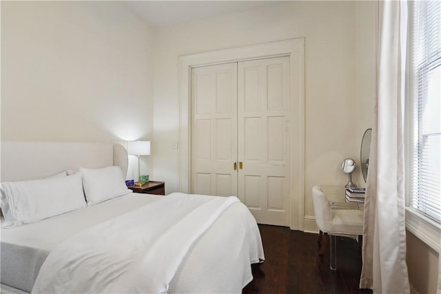 bedroom featuring a closet and dark wood-style flooring