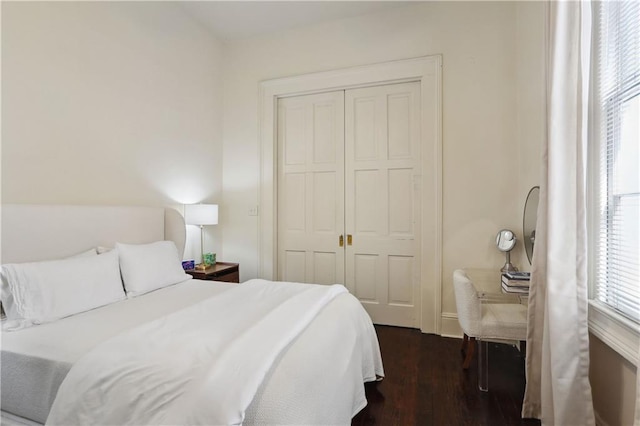 bedroom featuring a closet and dark wood finished floors