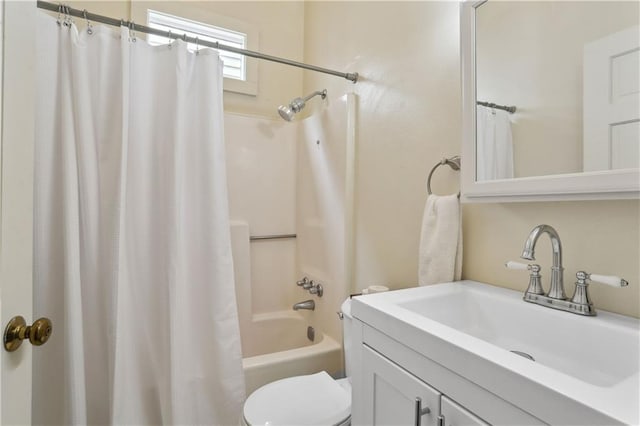 bathroom with toilet, shower / bath combo with shower curtain, and vanity