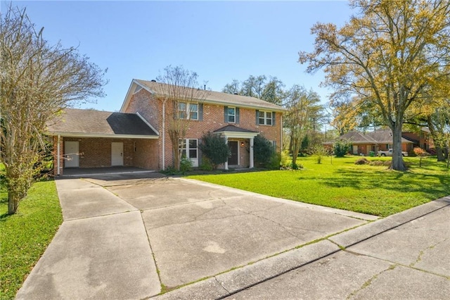 colonial house with brick siding, an attached carport, driveway, and a front lawn