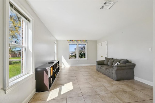 living room featuring visible vents, baseboards, and light tile patterned flooring