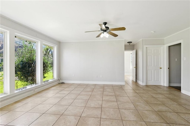 unfurnished room featuring ceiling fan, baseboards, ornamental molding, and light tile patterned flooring