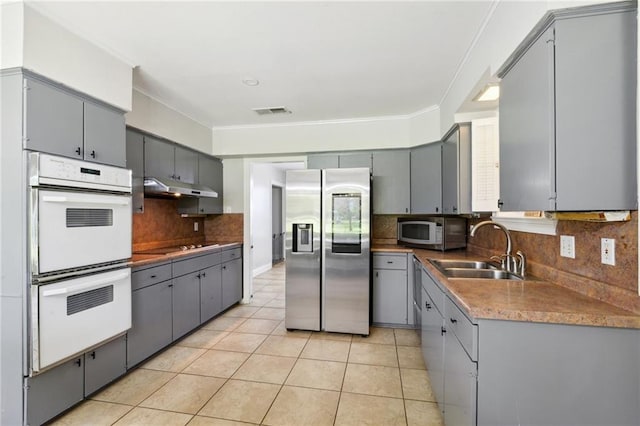 kitchen with white appliances and gray cabinetry