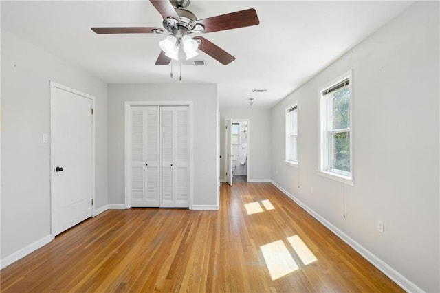 unfurnished bedroom with baseboards, visible vents, and light wood finished floors