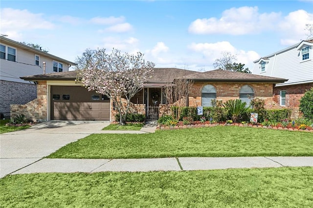 single story home with brick siding, a shingled roof, concrete driveway, a front yard, and an attached garage