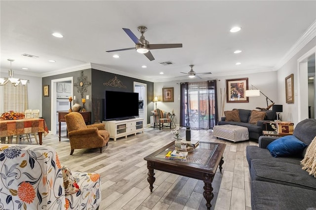 living area with visible vents, crown molding, and light wood finished floors