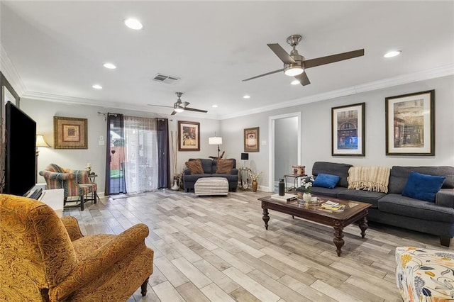 living room featuring visible vents, light wood-style floors, and ornamental molding