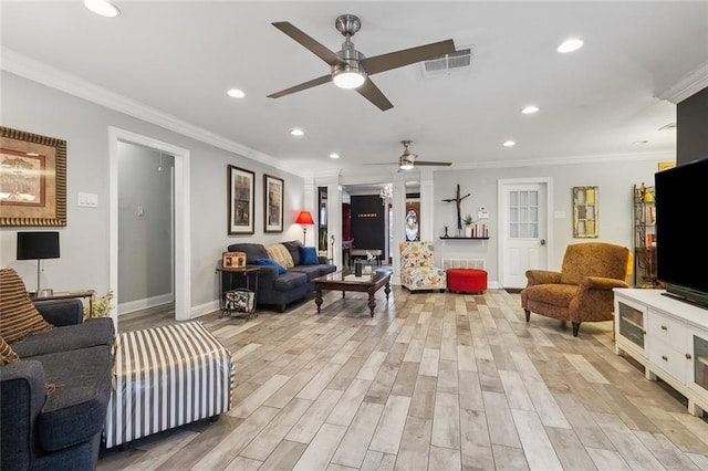 living room with light wood finished floors, visible vents, crown molding, baseboards, and recessed lighting