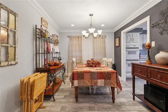 dining room featuring baseboards, light wood-style floors, a chandelier, and ornamental molding