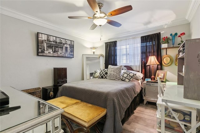 bedroom featuring ceiling fan, light wood-type flooring, and ornamental molding