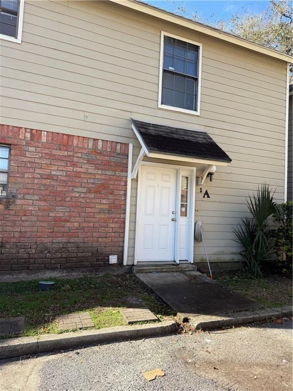 property entrance with brick siding