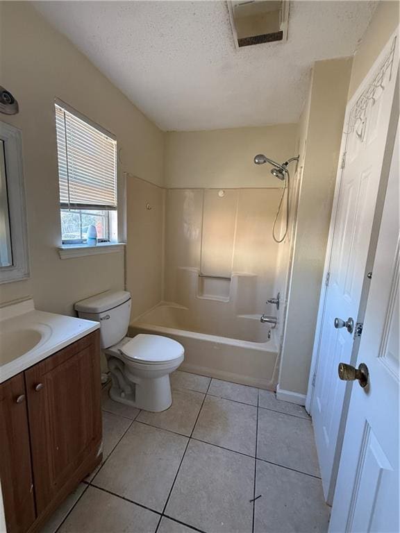 bathroom featuring vanity, visible vents, a textured ceiling, tile patterned floors, and toilet