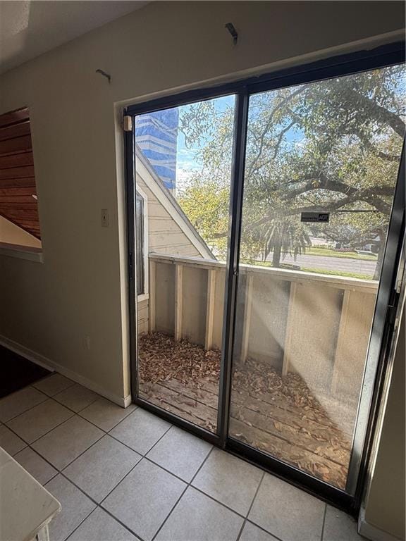 entryway with light tile patterned floors and baseboards