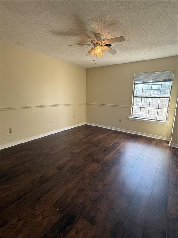 unfurnished room featuring dark wood finished floors, baseboards, a textured ceiling, and ceiling fan