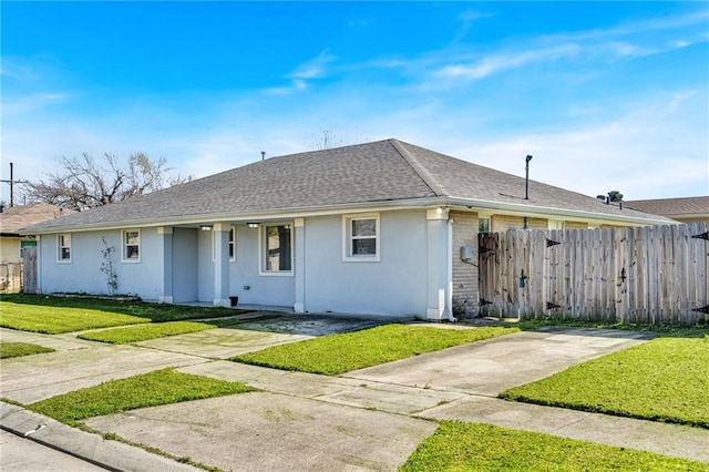 ranch-style house with brick siding, a front lawn, and fence