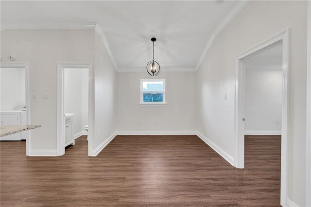 unfurnished dining area with separate washer and dryer, dark wood-type flooring, baseboards, and ornamental molding