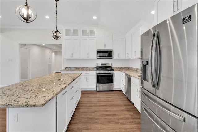 kitchen featuring ornamental molding, dark wood finished floors, a center island, white cabinetry, and appliances with stainless steel finishes