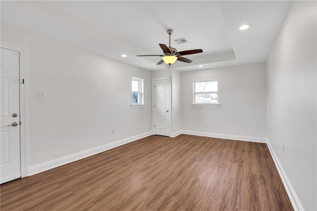 spare room with visible vents, a ceiling fan, wood finished floors, recessed lighting, and baseboards