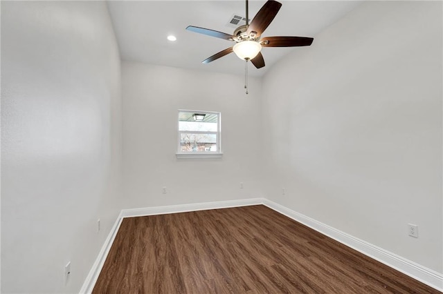 unfurnished room with dark wood finished floors, visible vents, baseboards, and ceiling fan