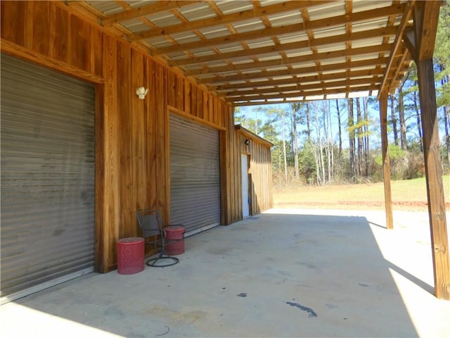 view of patio featuring a carport and a garage