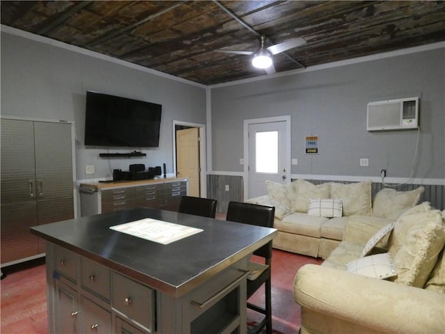 kitchen featuring a center island, open floor plan, a wall mounted air conditioner, ornamental molding, and a ceiling fan