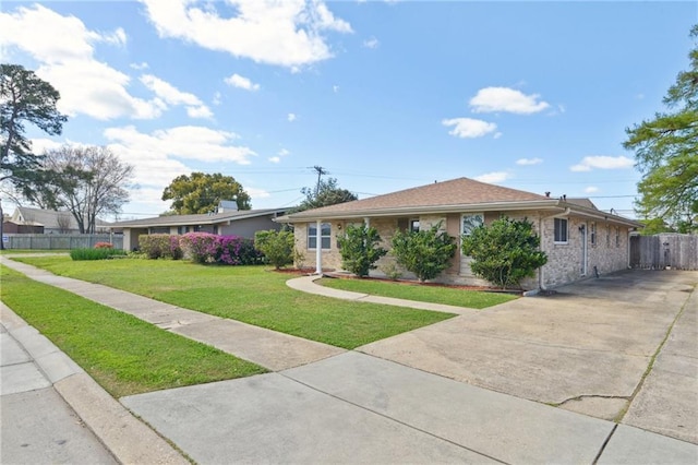 ranch-style home with brick siding, concrete driveway, a front yard, and fence