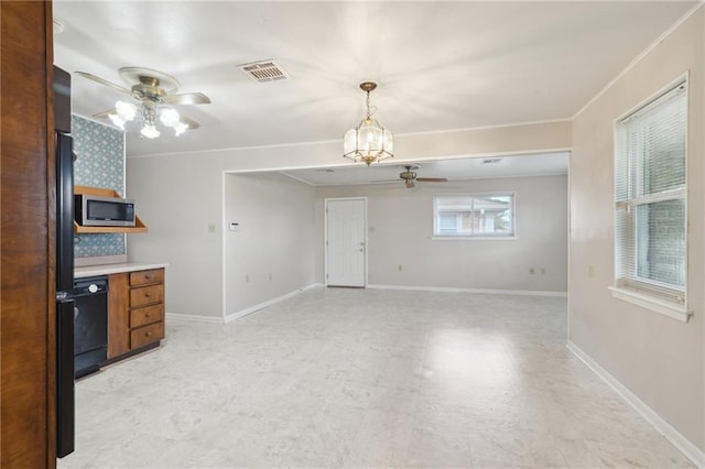 kitchen with visible vents, baseboards, dishwasher, stainless steel microwave, and ceiling fan with notable chandelier