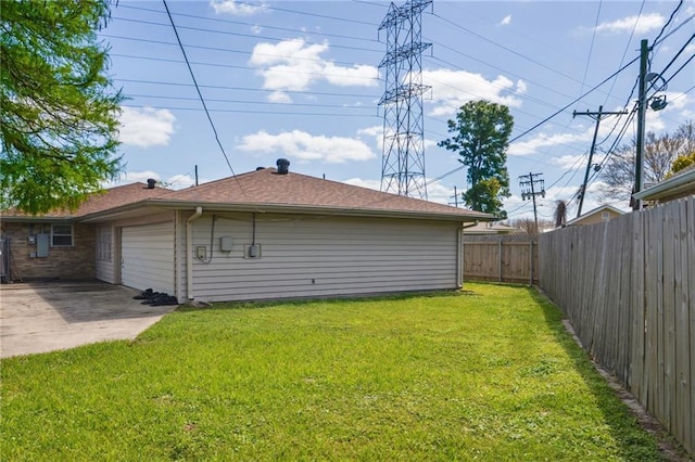 exterior space featuring a patio, an attached garage, a fenced backyard, and concrete driveway