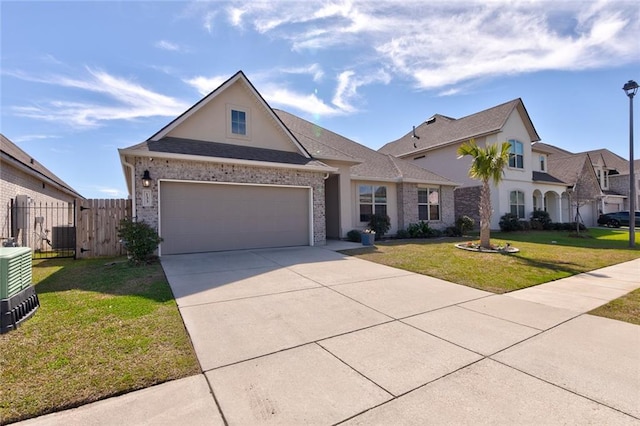 view of front of house featuring brick siding, fence, concrete driveway, roof with shingles, and a front yard