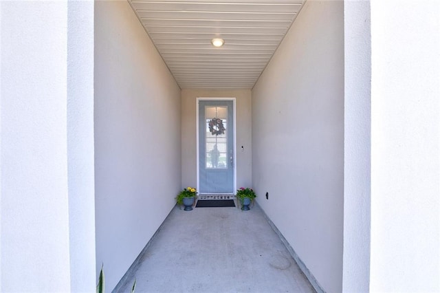 view of exterior entry with stucco siding