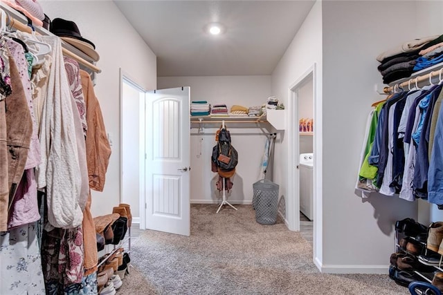 spacious closet featuring washer / clothes dryer and carpet