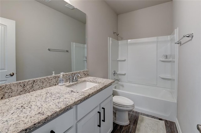 bathroom with shower / washtub combination, toilet, vanity, and wood finished floors