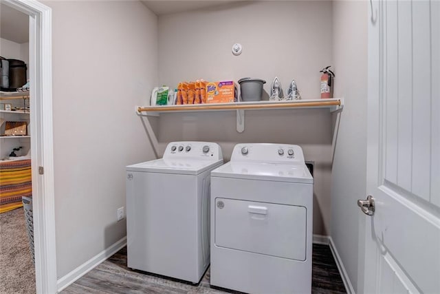 laundry room with baseboards, independent washer and dryer, wood finished floors, and laundry area