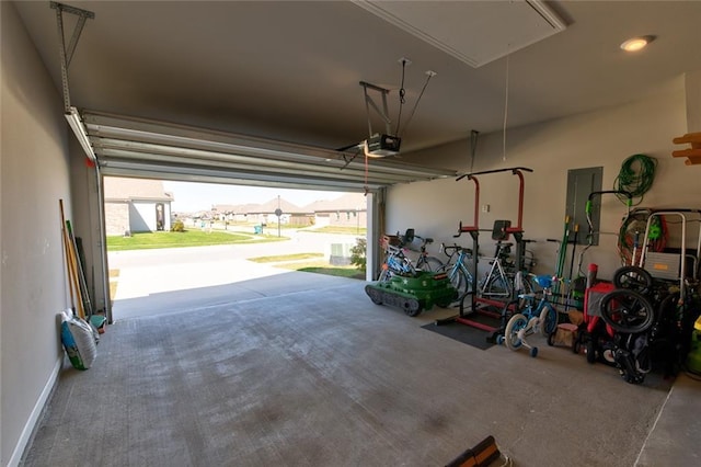 garage with electric panel and a garage door opener