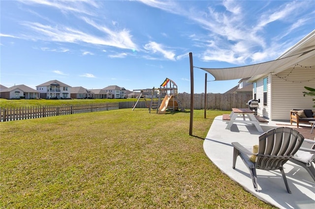 view of yard with a patio, a playground, a fenced backyard, and a residential view