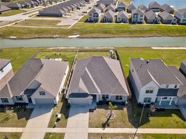 drone / aerial view featuring a residential view and a water view