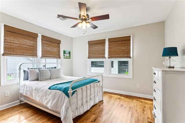 bedroom featuring light wood-style flooring, baseboards, and visible vents