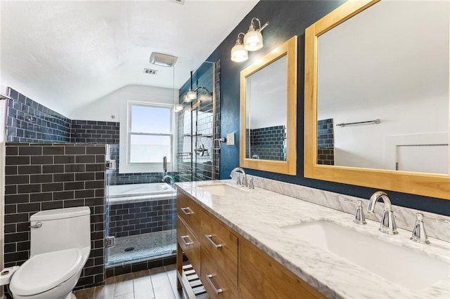 full bath featuring a sink, toilet, double vanity, and a tile shower