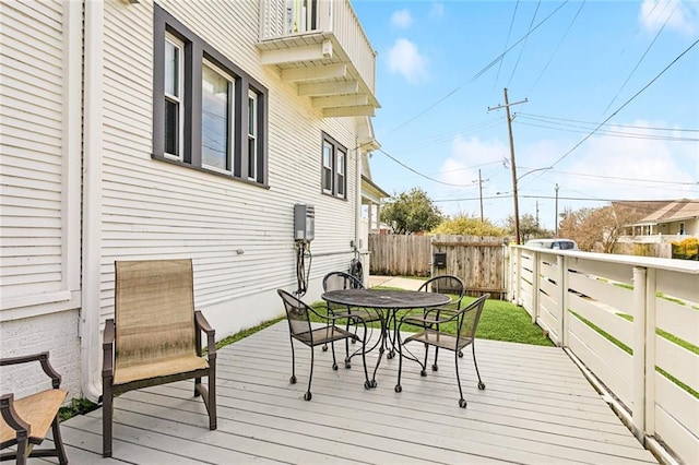 wooden terrace featuring outdoor dining area and fence