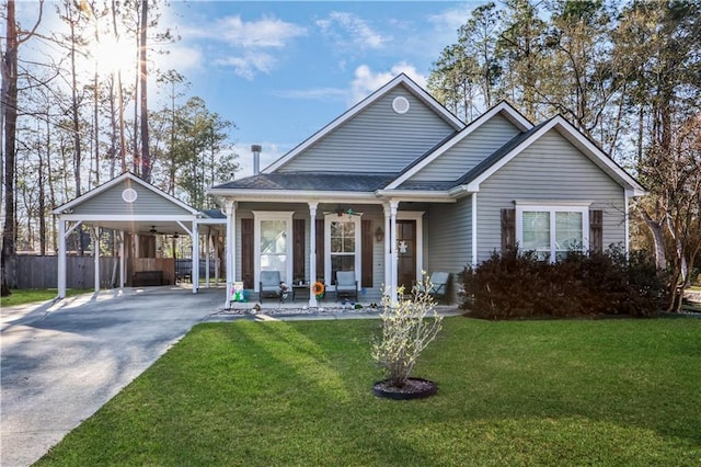 view of front of property featuring a front yard, driveway, a porch, ceiling fan, and a carport