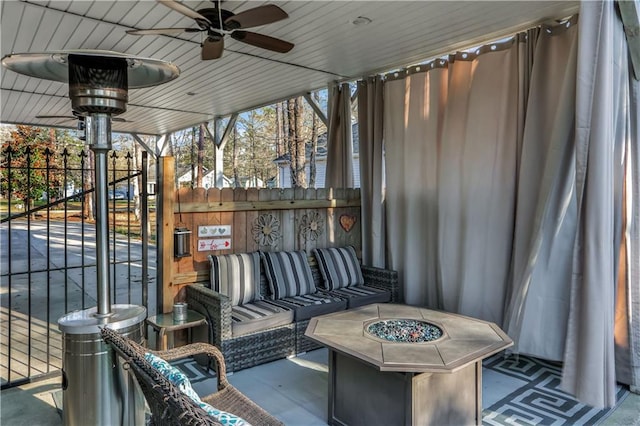 view of patio / terrace featuring an outdoor living space with a fire pit, a gate, and ceiling fan