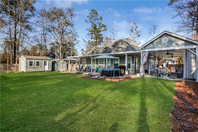 back of property featuring fence private yard, a patio, a storage shed, and an outdoor structure