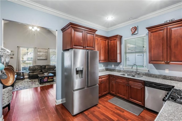 kitchen featuring a sink, crown molding, dark wood finished floors, and stainless steel appliances