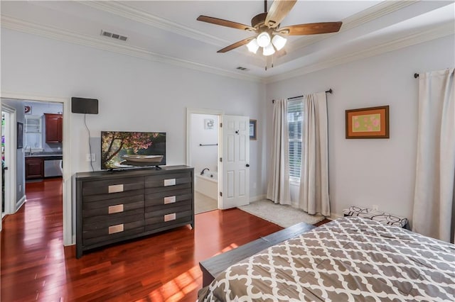 bedroom with dark wood finished floors, visible vents, crown molding, and baseboards