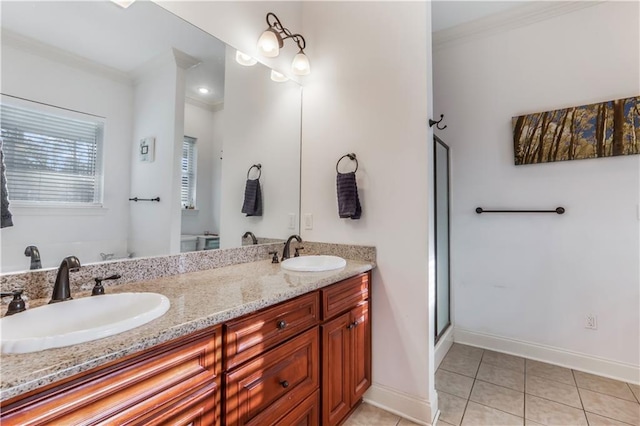 bathroom with tile patterned flooring, ornamental molding, and a sink