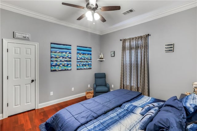 bedroom featuring visible vents, ornamental molding, wood finished floors, baseboards, and ceiling fan