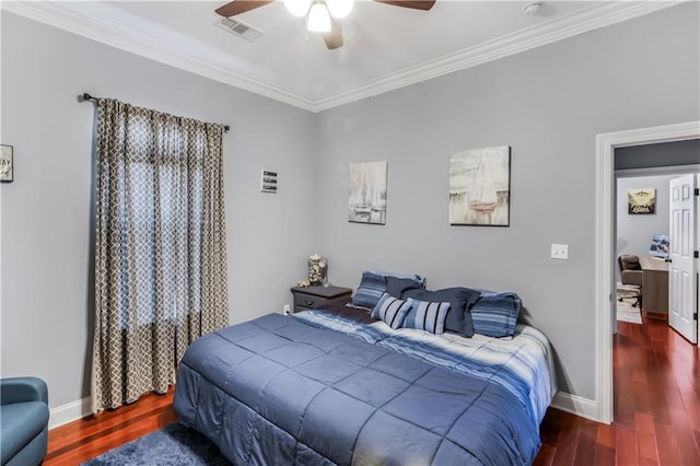 bedroom featuring crown molding, wood finished floors, visible vents, and baseboards