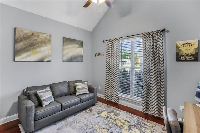 living area with vaulted ceiling, wood finished floors, a ceiling fan, and baseboards